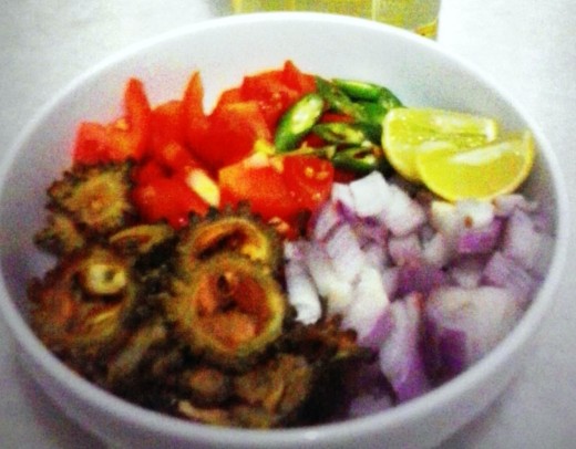 Diced tomatoes, onions, green chiles, salt and lime ready to mix with fried bitter gourd