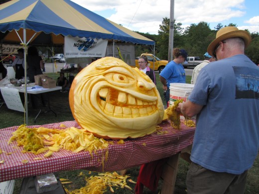 A pumpkin carver at work at the fall festival in Sanford, Maine.