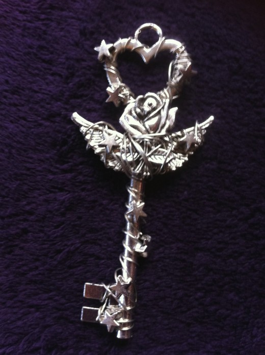 This mystical key pendant- Love theme key with a romantic rose, wings and hand twisting, weaving wire with stars in order to create eye catching and unique neckless.  Pendant measures 8.5 cm including the bail and it can 