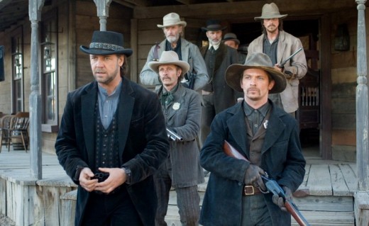 Russell Crowe (from left, wearing a black suit) and Christian Bale (back right, wearing a light brown jacket), both looking tough, out in the wild-wild-west.