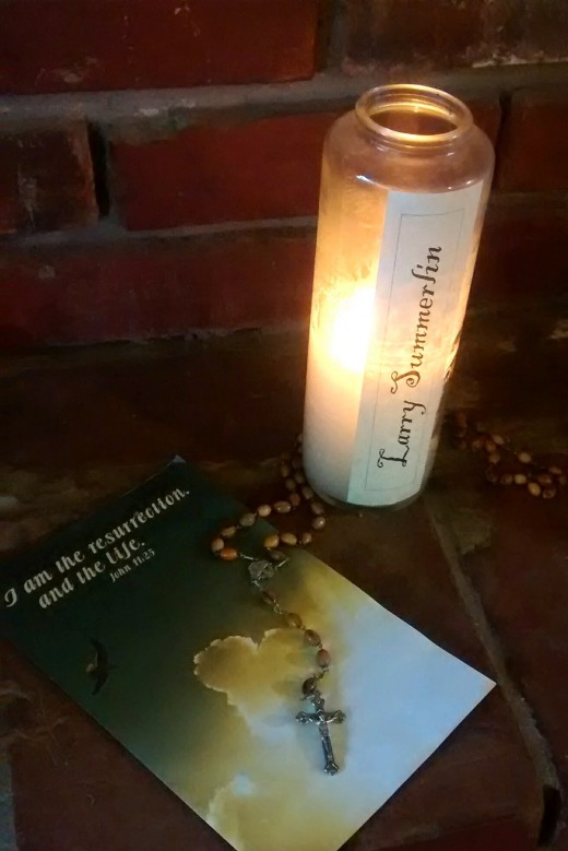 This is the candle used in last year's All Souls' celebration along with a bulletin from Dad's funeral and the rosary he bought for me in Israel.