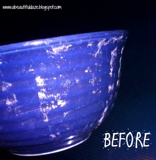 A blue bowl with hard water stains and dried soap encrusted along the sides of it.