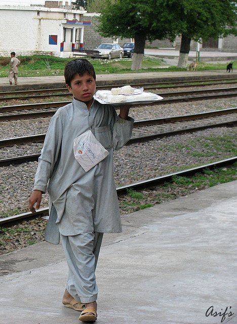 A child selling sweets at a railway station