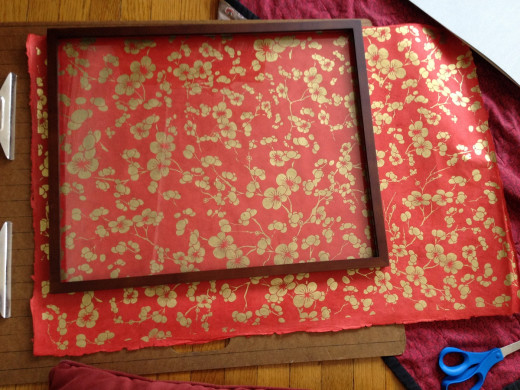 Step 5. Place the frame and glass over the art paper, design side up, until you've found exactly the portion of the design you want to show when it is hanging on the wall.