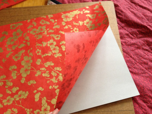 Step 7. Repeat the tape procedure in Steps 3 & 4, securing the art paper, design side up, against the backing.