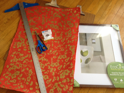 Step 1: Assemble your materials and tools and a soft pad to place under your hard work surface so you don't inadvertently score your table (or in my case, the floor) when you cut the paper. I used a small quilt.