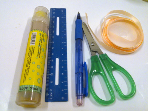 glue, ruler, pencil, a pair of scissors and ribbons