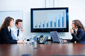 Charts seen on big-screen monitors help big corporate meetings to be organized