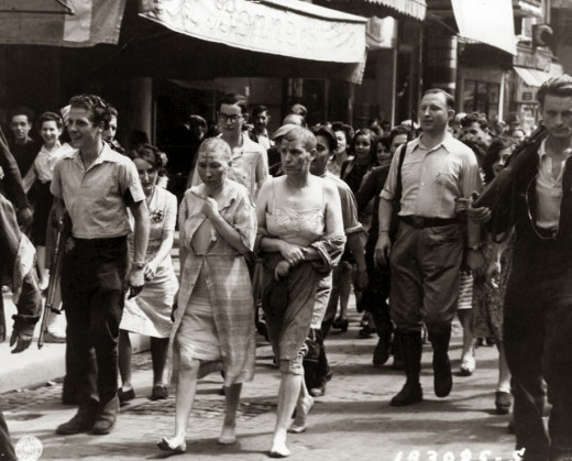 Humiliated French women, shaved, are forced to march through the streets of Paris. World War II, circa 1944