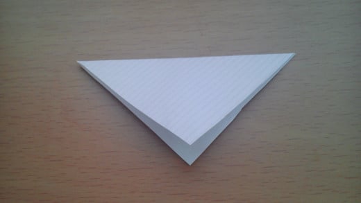 Fold the top corner down to make a triangle. Make sure your upper and lower edges are aligned.