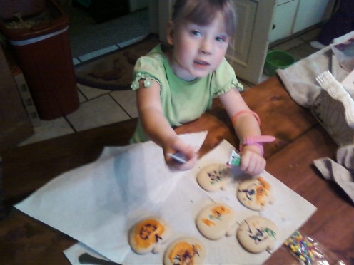 3) Start putting colored icing upon your cookies.