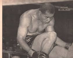 Joe Louis, "The Brown Bomber," sits dazed about a hard punch by Rocky Marciano