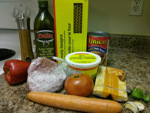 Black pepper, red pepper, ground meat (beef), oil, oven-ready lasagna noodles, pasta sauce, cottage cheese, tomato, marble cheese, carrot, garlic, basil herbs
