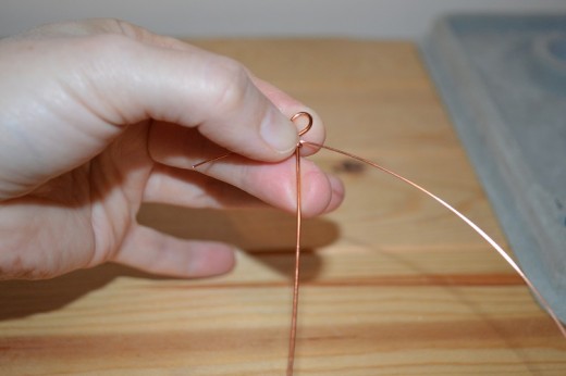 Holding the 0.6mm gauge wire in position before securing it into place
