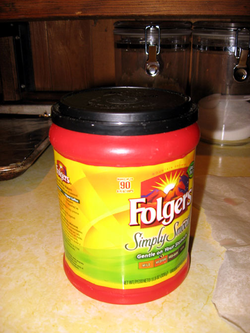 A plastic coffee can is perfect for collecting leftover candles and melted scent-depleted wax from Scentsies.