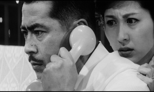 Gondo (Toshirō Mifune) and his wife (Kyōko Kagawa) play cat-and-mouse with an unseen kidnapper in Akira Kurosawa's High and Low (1963)