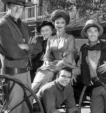 CAST OF GUNSMOKE (from left) James Arness; Milburn Stone; Amanda Blake; Ken Curtis and Burt Reynolds, sitting
