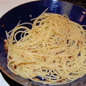 Add drained spaghetti to pan and toss to coat spaghetti with anchovy and garlic oil.