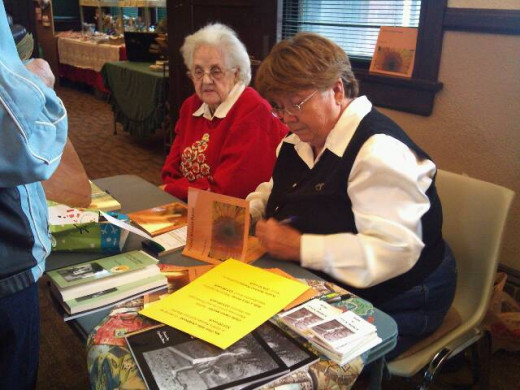 Ross and her mother holding a joint- booksigning.