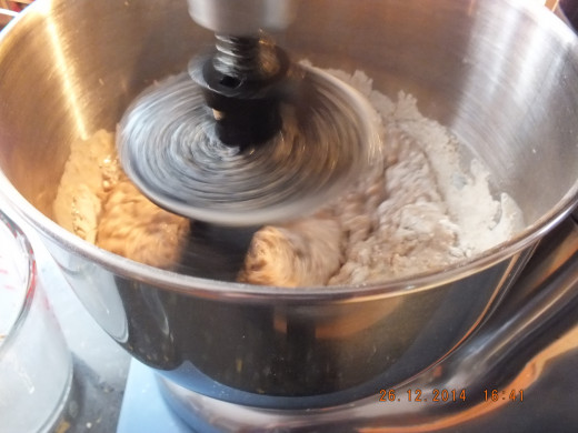 Now add a cup of bread flour and continue mixing until all ingredients come together. 