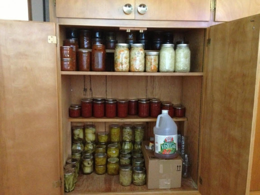 The top shelf has 5 jars of naturally fermented Kimchi and Kraut.  to reduce spoilage, I will probably move them to the refrigerator once I am sure fermentation is over.  