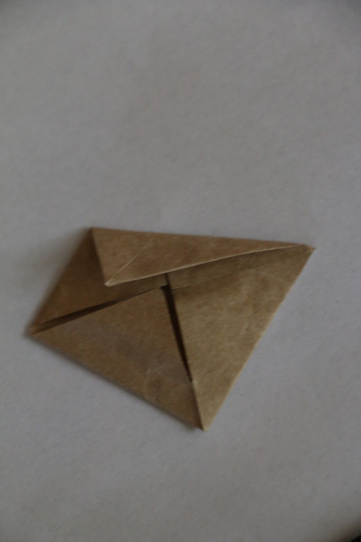 Fold two sides to the centre to make a kite shape