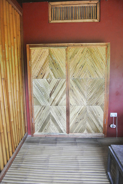Our house is small and I hated the brooms and other cleaning things left out so I had this floating broom closet made. To the left is the screened whole bamboo wall to the kitchenette and the floors are the traditional Filipino style slats.