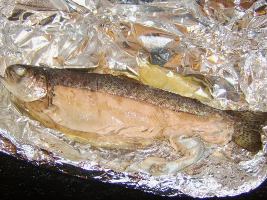 Starting to remove skin from baked rainbow trout