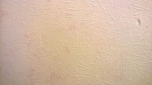 A bathroom wall scumbled using semi-gloss latex paint.