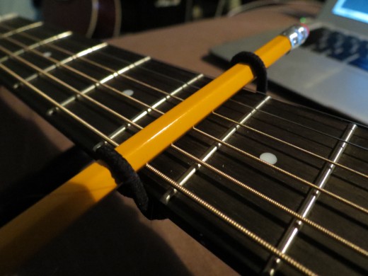 Now the makeshift capo is secure, but as I said before it will take a few more to achieve the right amount of tension. Simply repeat this until the strings play clean with no buzzing.