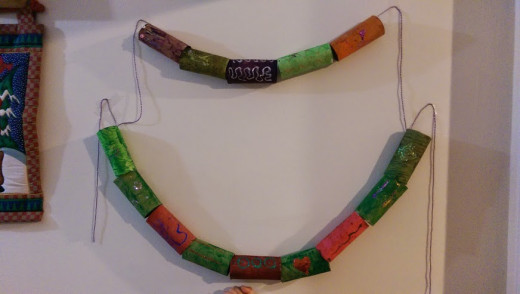 your painted toilet paper roll craft can be shaped into a garland, a wreath, or even a mobile!
