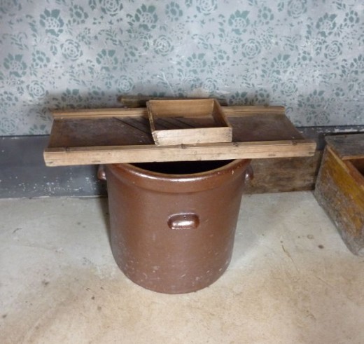 Here is an old-time mandolin and sauerkraut crock. Both were used to make sauerkraut quickly and easily. 