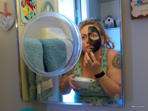 Applying the facial Activated Charcoal to the face.