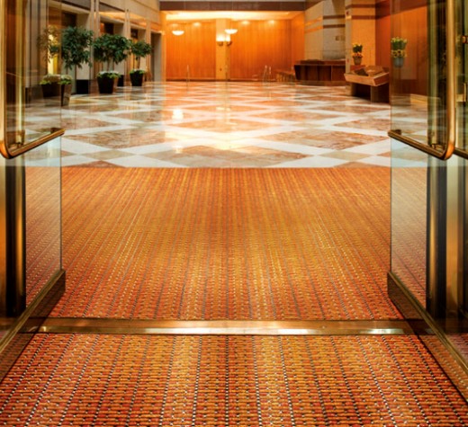 Aesthetic specialty entrance flooring solutions can be customized to match main floor.
