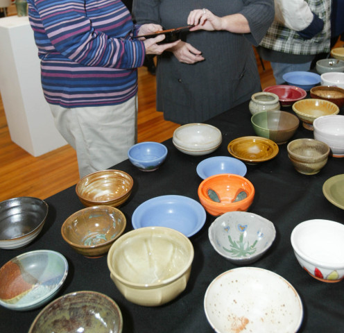 A table of bowls created by local artists for the Empty Bowl fundraiser. Attendees purchase a bowl and receive a lunch of soup in return. All proceeds go toward the Alton Crisis Food Center. 