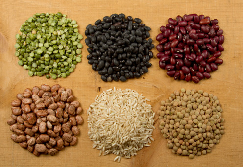 An assortment of beans, along with rice. A combination of rice and beans provides a complete protein. Beans provide fiber, potassium, folate, iron, manganese and magnesium, and they are cholesterol- and fat-free. 