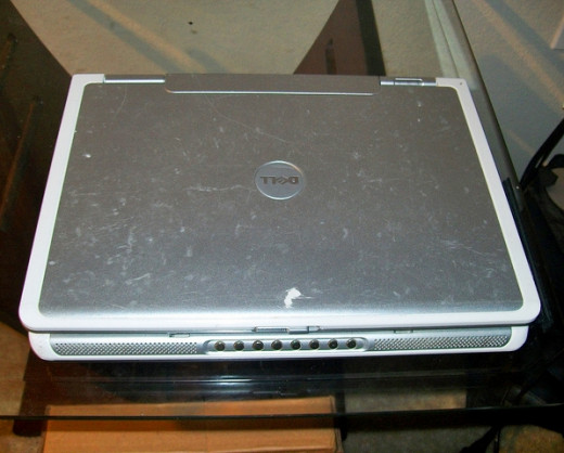 Laptop with scratches, signs of prior falls