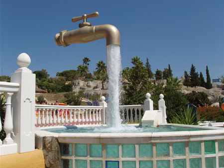 The magic tap in Aqualand,Spain.The tap appears to float in the sky with an endless supply of water. Actually, there is a pipe hidden in the stream of water that holds the whole structure.