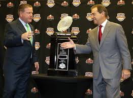 Brian Kelly, left, Notre Dame, Nick Saban, Alabama shake hands at media event before the two met in a BCS National Championship Game in which Bama won