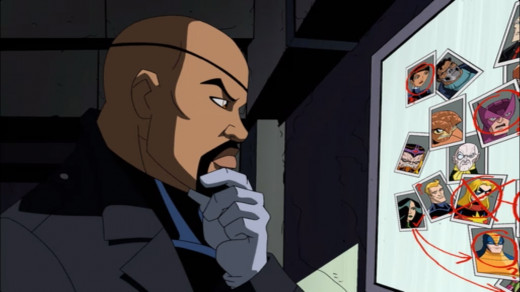 "Nick Fury stood in front of a bulletin board with pictures of various heroes on it."
