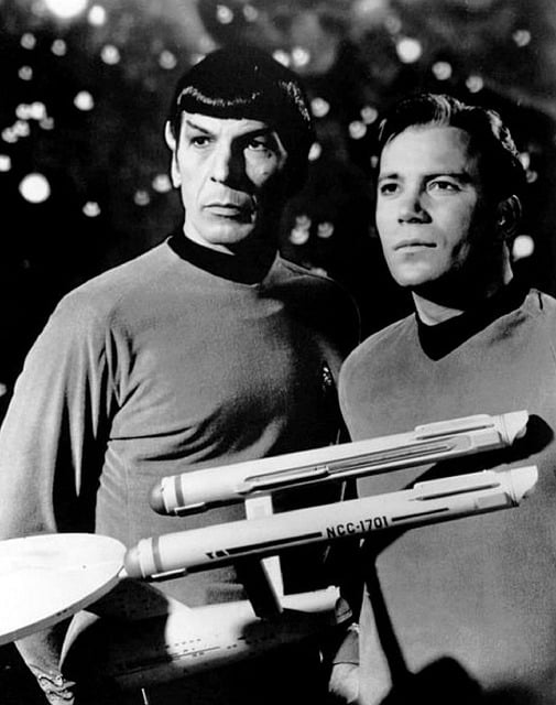 Leonard Nimoy as Science Officer Spock and William Shatner as Captain James Tiberius Kirk with a model of the Enterprise NCC-1701.