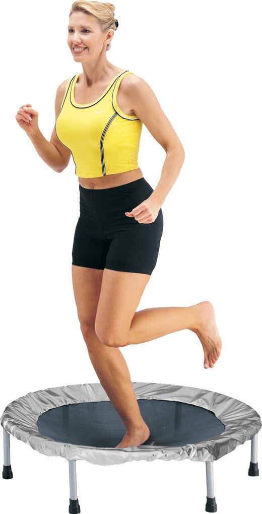 A woman jumping or rebounding on a mini trampoline.