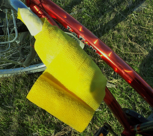 Wrap toward the end of the hand grip then wrap around the end and back toward the handlebar.