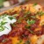 Pizza Skins - garlic mashed potatoes, cheddar cheese, bacon and scallions, baked on a pizza dough and then topped with sour cream.