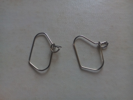 An earring hook wherein the beads hang behind the ear.