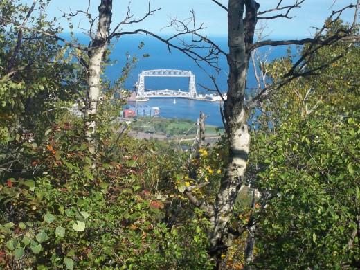 A picture of the Aerial Lift Bridge through the trees up in the Park by Enger Tower