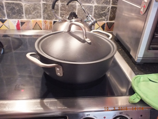Place a tightly fitting lid on your dutch oven and carefully transfer it to your main oven for about an hour.