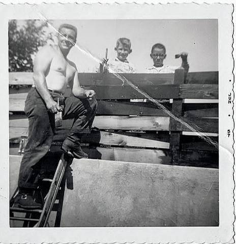 My dad and I and Mr. Streitz's son painting our fence