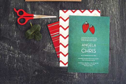 A bright red strawberry pops in a chalkboard green background