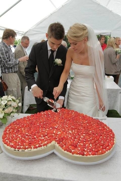 Have a big hear-shaped wedding cake. Why not? And since strawberries are heart-shaped too, go all out and top it with lots and lots of strawberries.